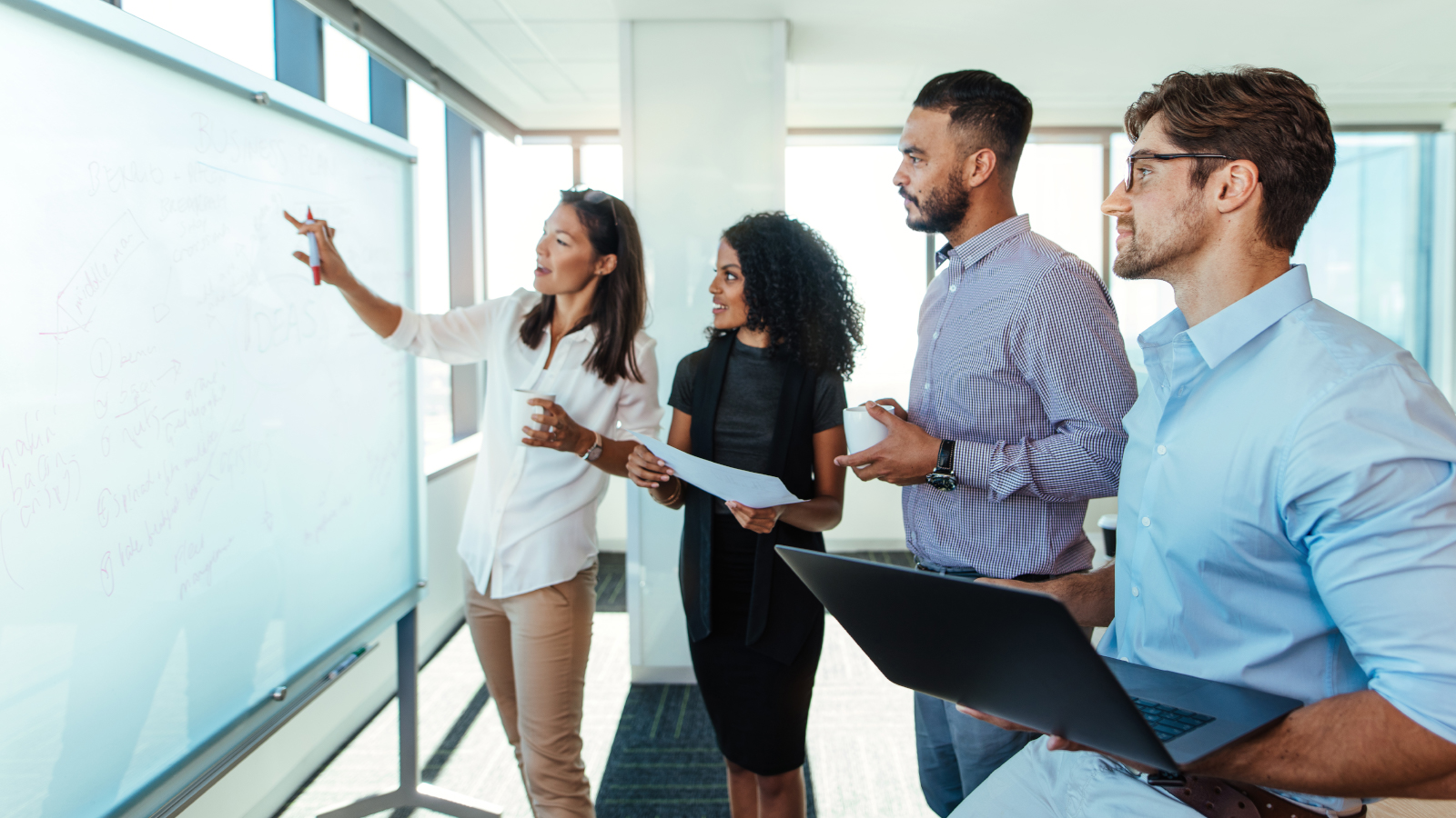 business team reviewing plan on white board