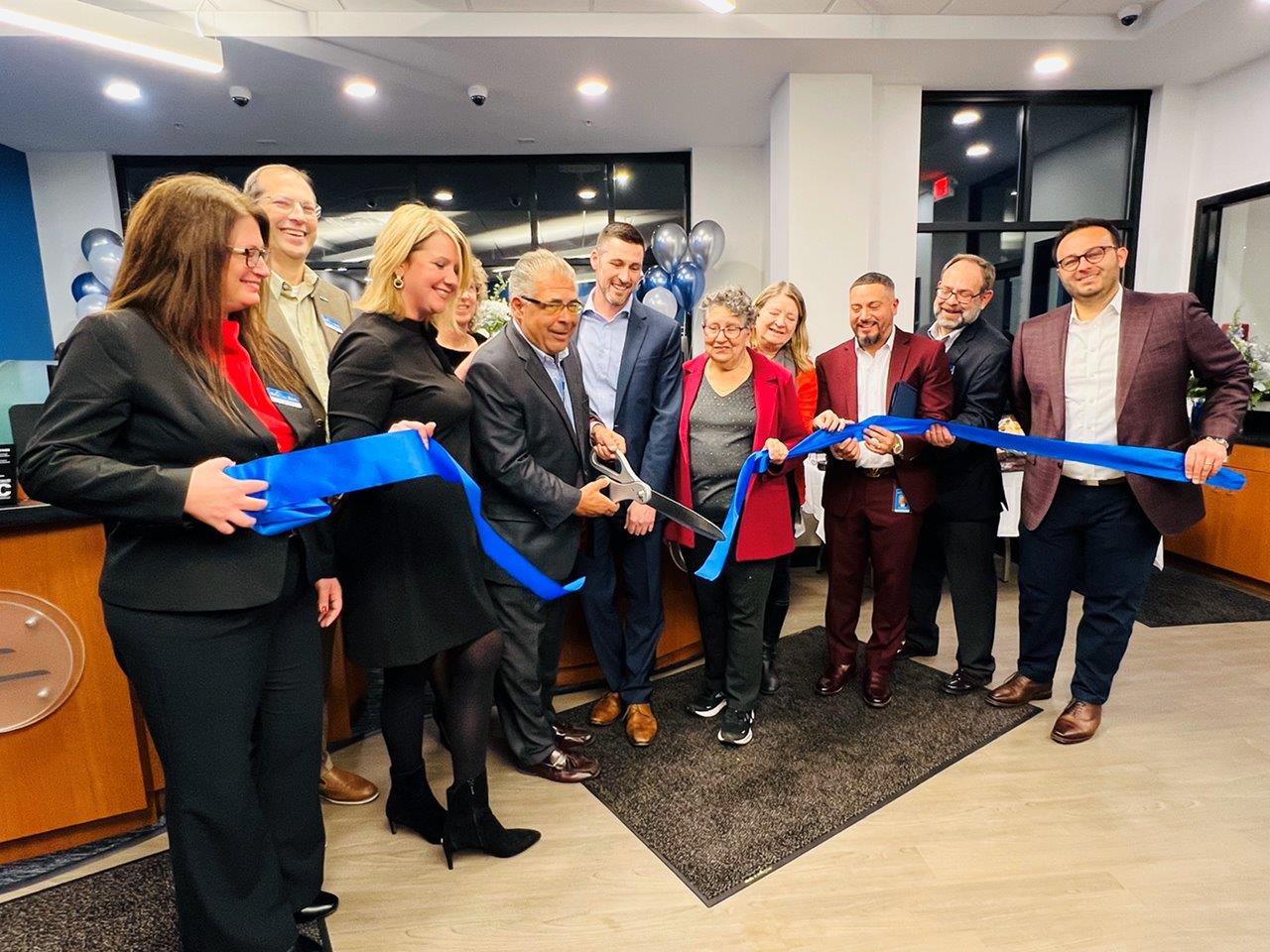 Photo of team cutting the ribbon at the Williamsville Grand Opening